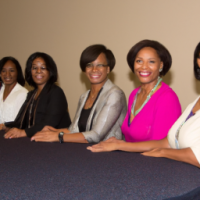 Black women aged 42 in a conference, 6 of them corporately dressed